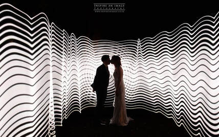 Couple kissing with light trails behind them.